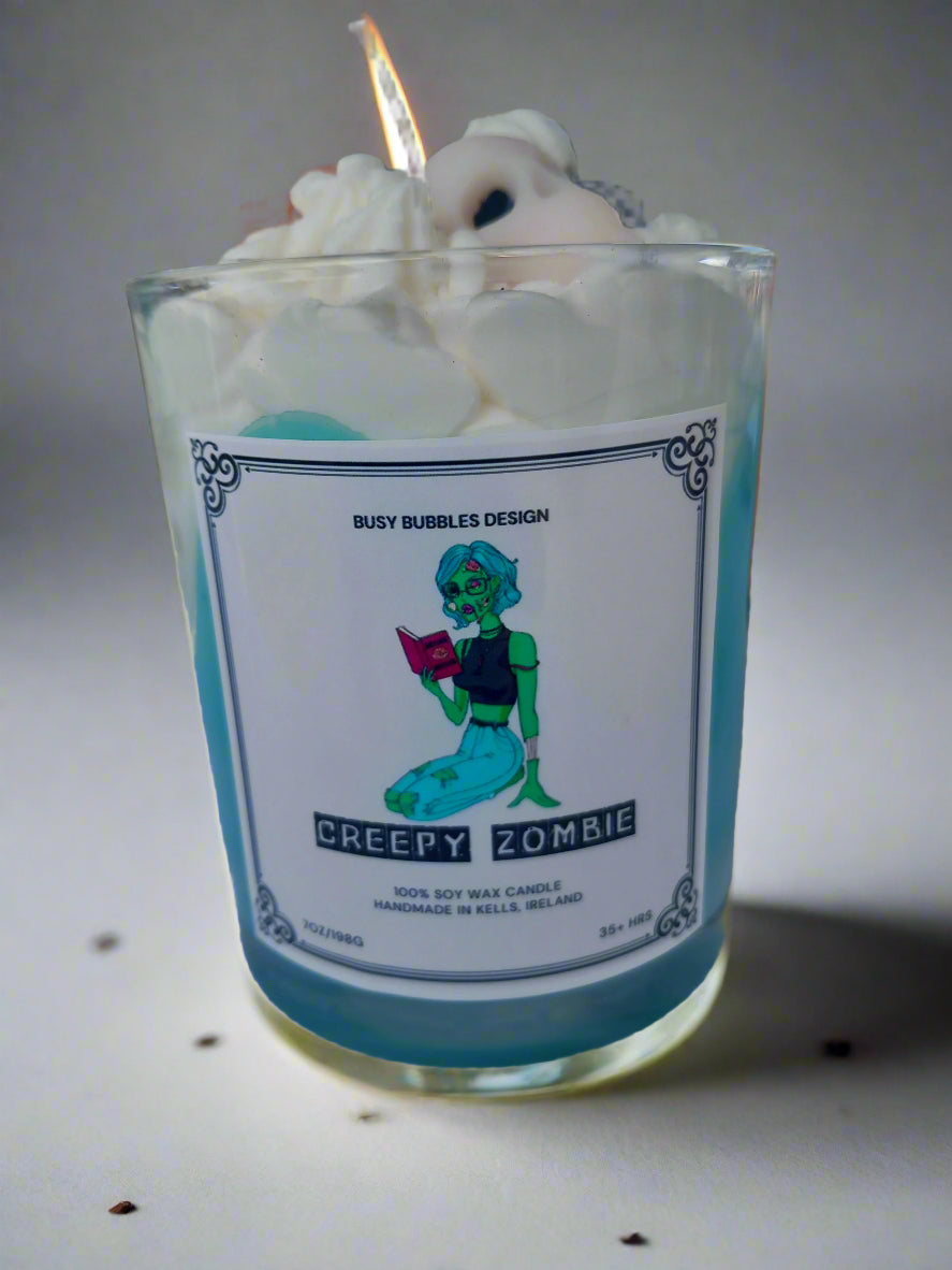 Candle with a label featuring a zombie design on a blurred background